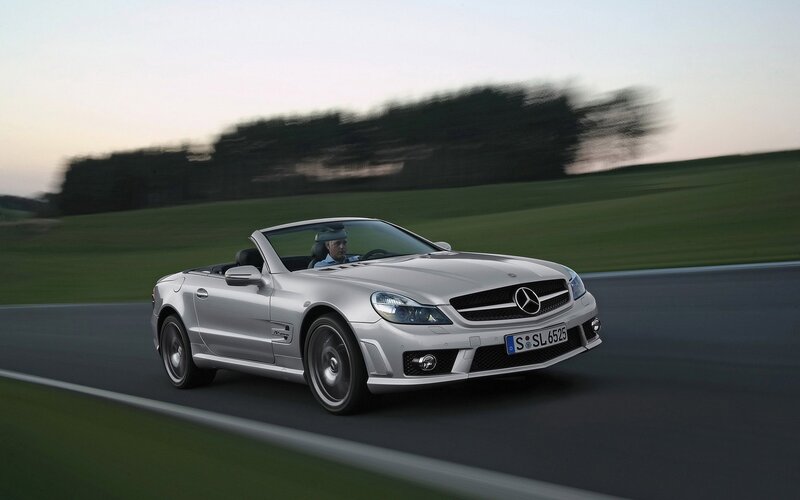 Silver Mercedes-Benz SLK driving on track
