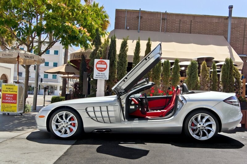 Silver Mercedes-Benz SLR parked outside restaurant