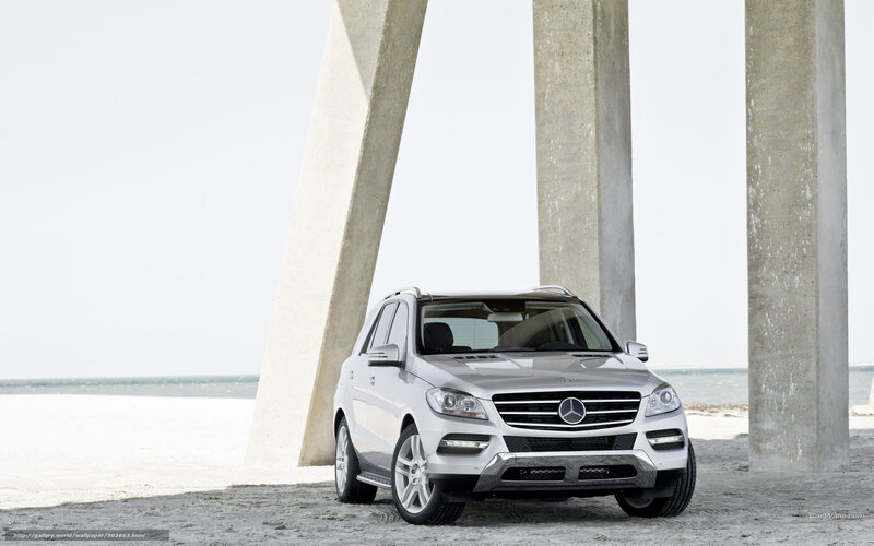 Silver Mercedes-Benz SUV on beach