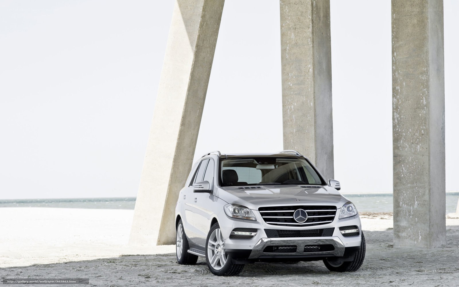 Silver Mercedes-Benz SUV on beach