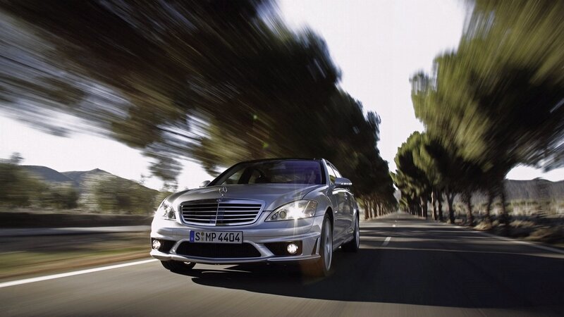 silver mercedes driving on road