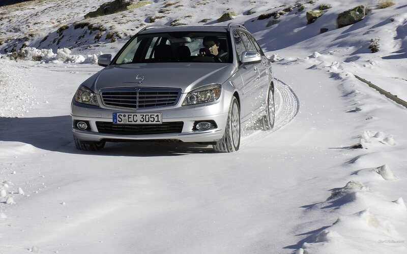 Silver Mercedes driving on snowy road