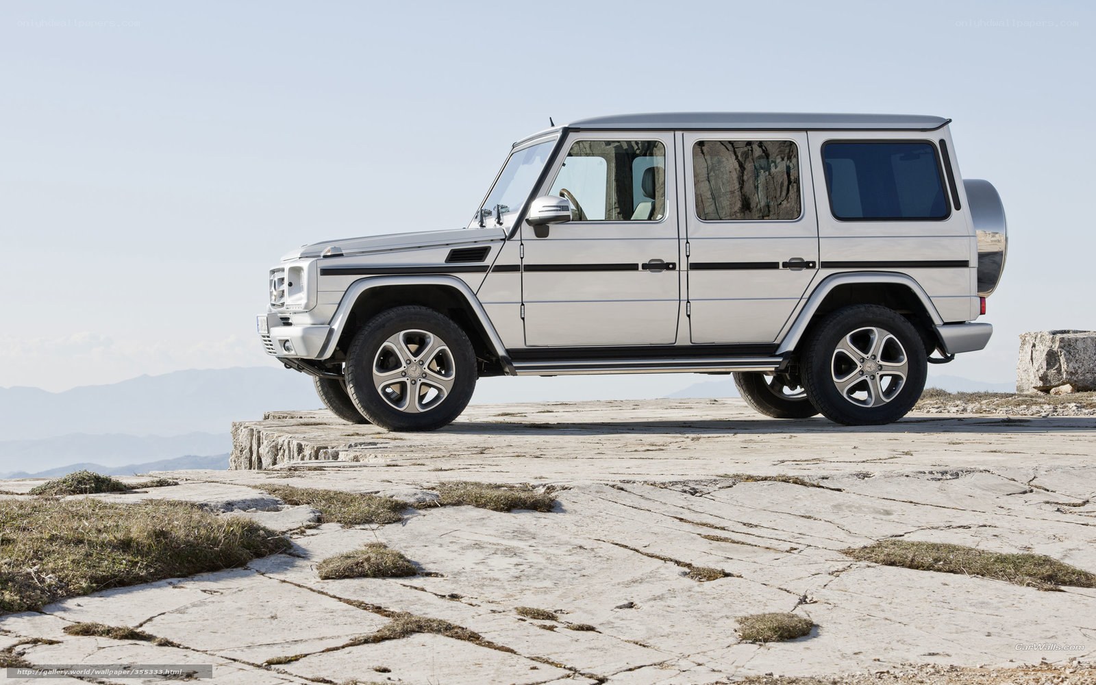 silver mercedes g-wagon on cliff