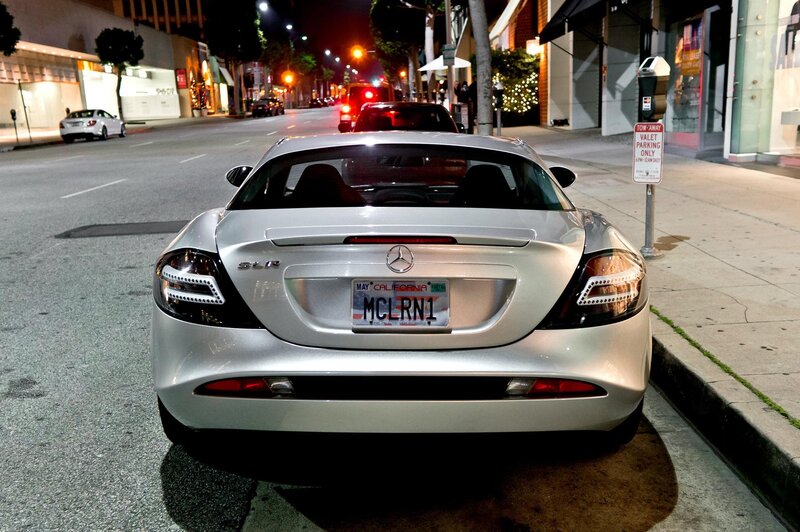 Silver Mercedes SLR parked on city street