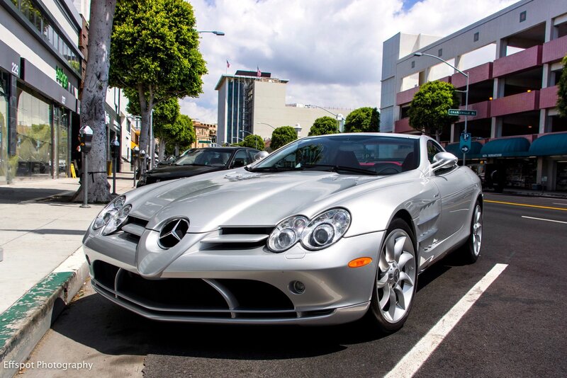 Silver Mercedes SLR parked on street