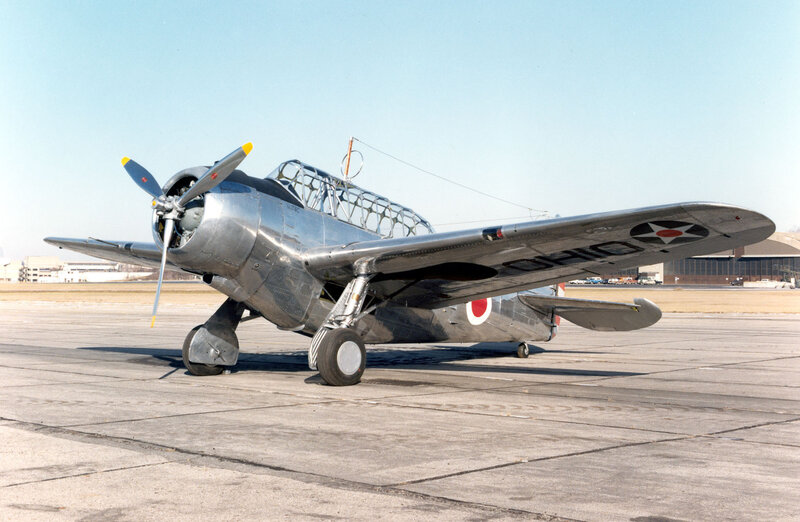 Silver military aircraft on tarmac