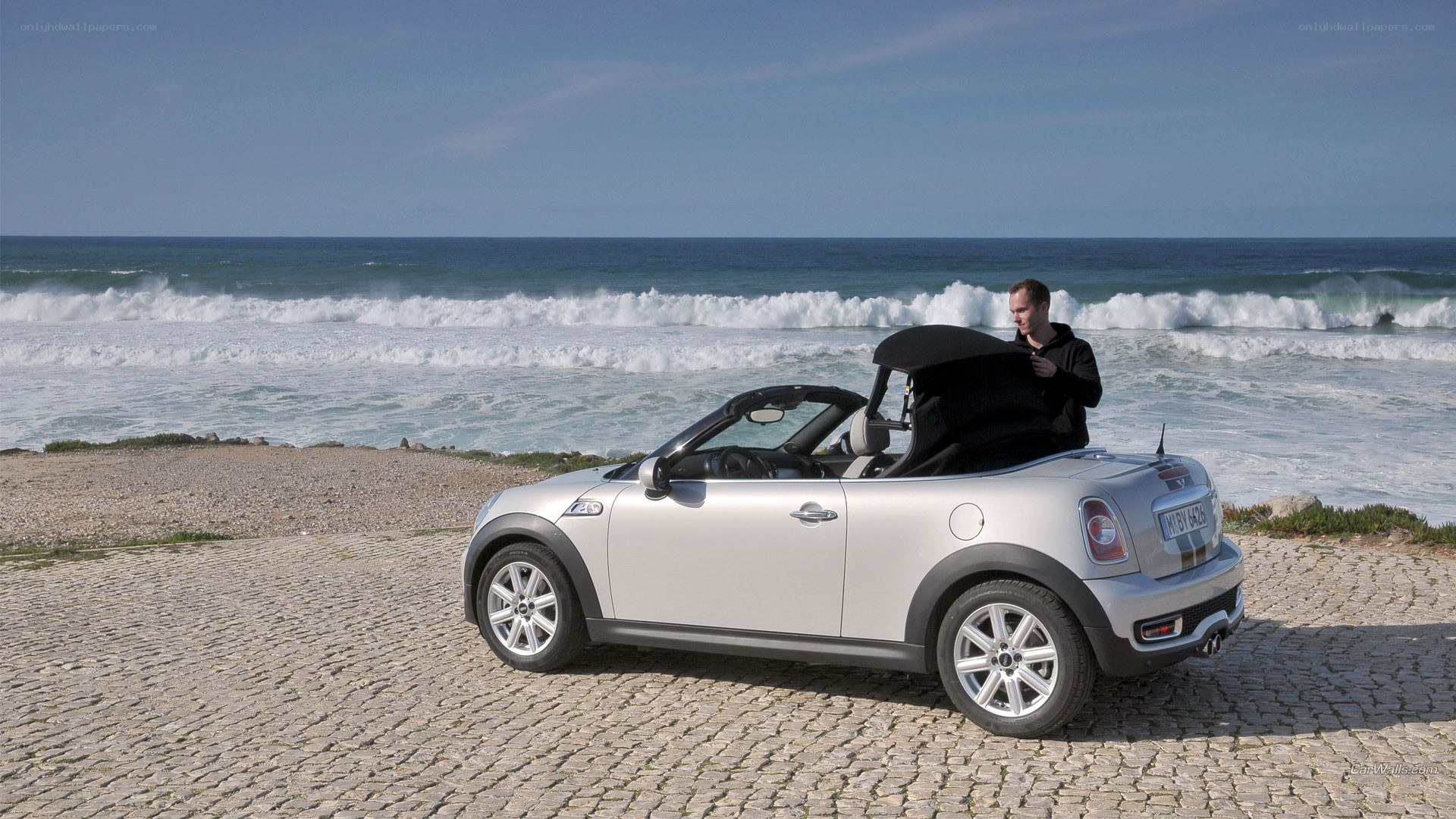 Silver MINI convertible on beach