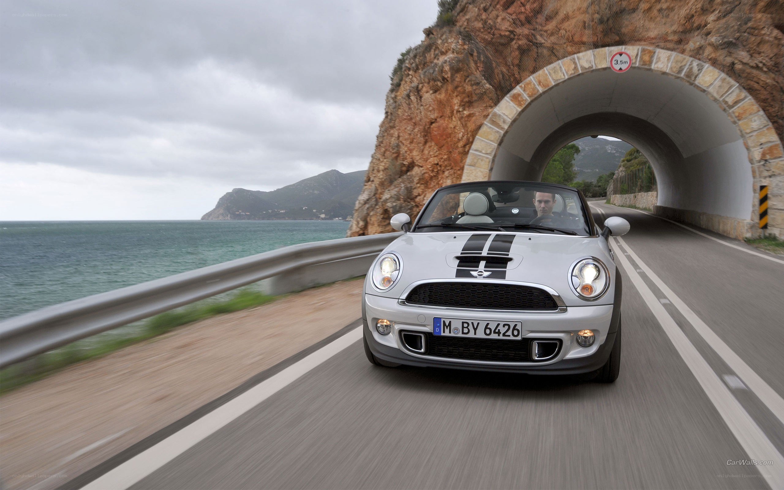 Silver MINI convertible on coastal road