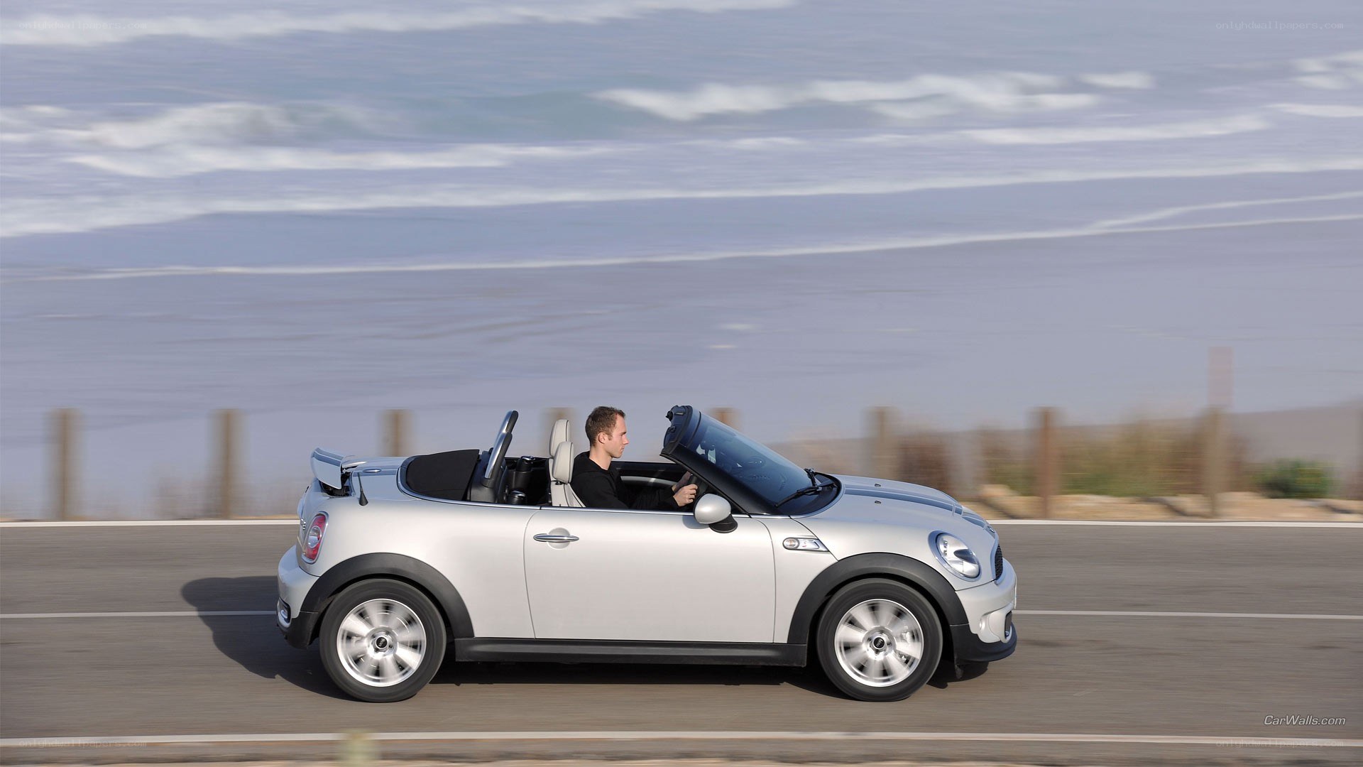 Silver MINI convertible on coastal road