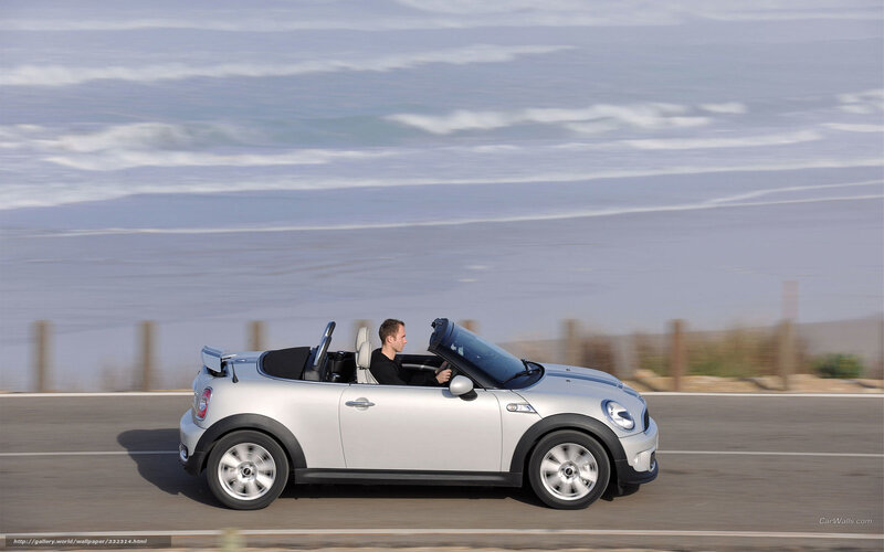 Silver MINI convertible on coastal road