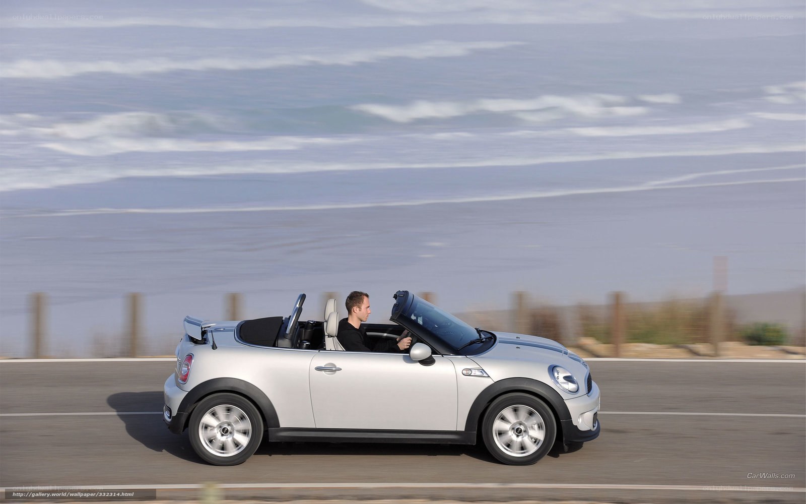 Silver MINI convertible on coastal road