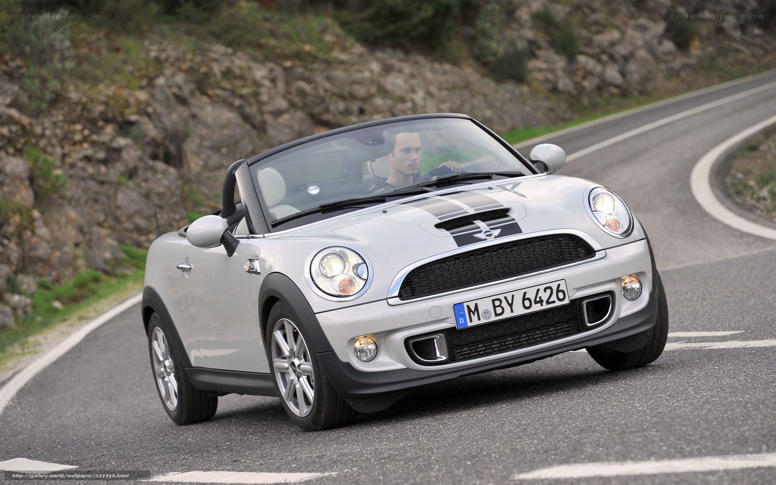 Silver MINI Cooper convertible on winding road