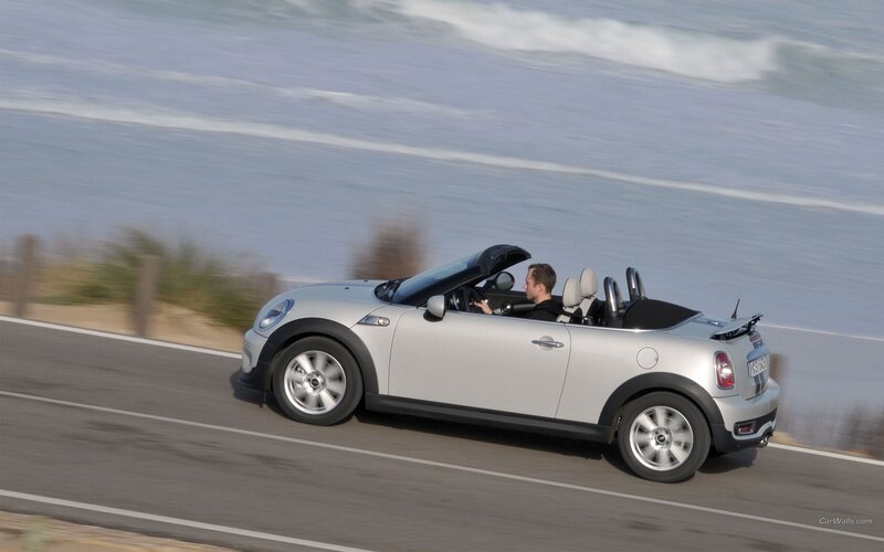silver mini cooper driving on coast