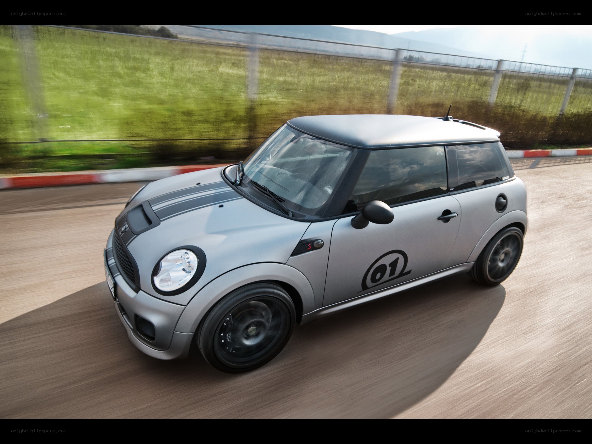 silver mini cooper on track