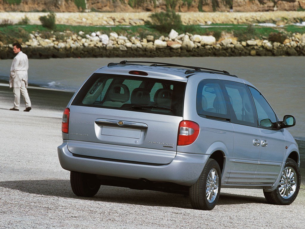 silver minivan on beach