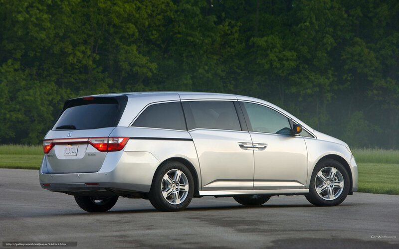 silver minivan on paved road