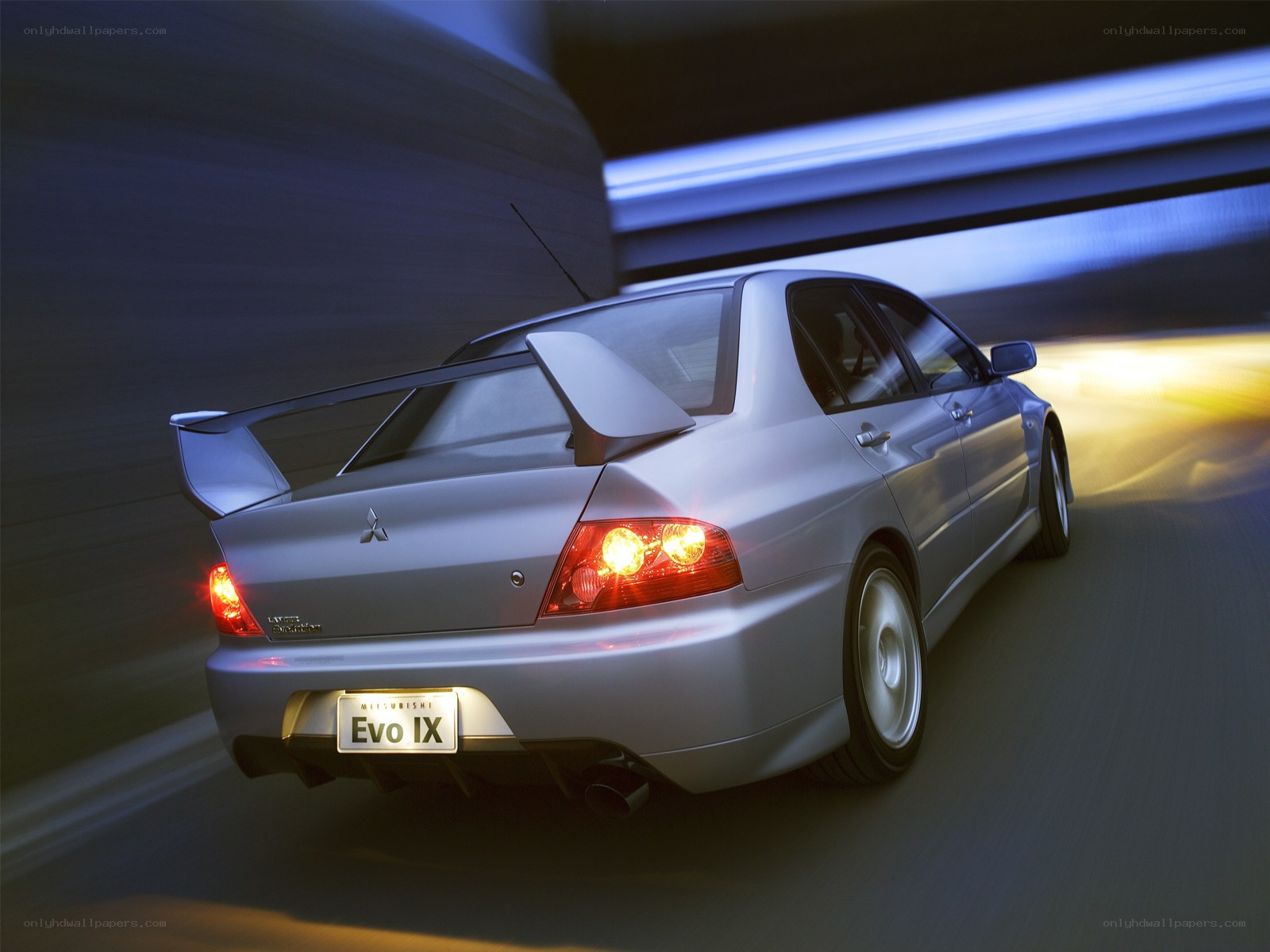 Silver Mitsubishi Evo IX in motion