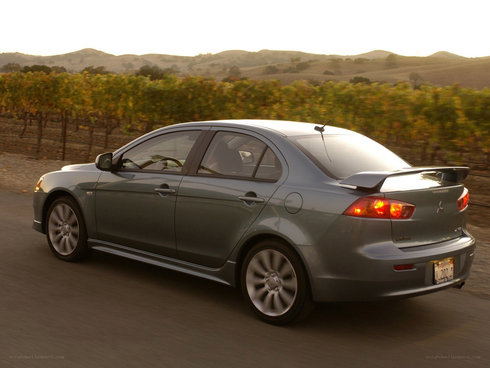 silver mitsubishi lancer driving