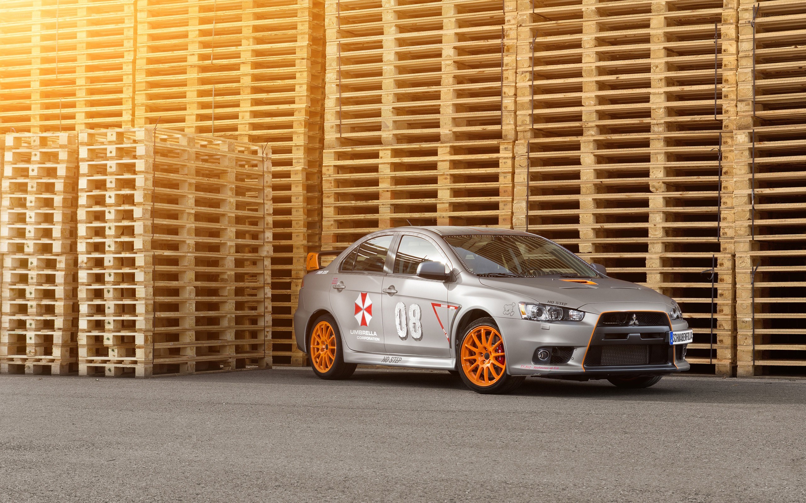silver mitsubishi lancer evo with orange wheels