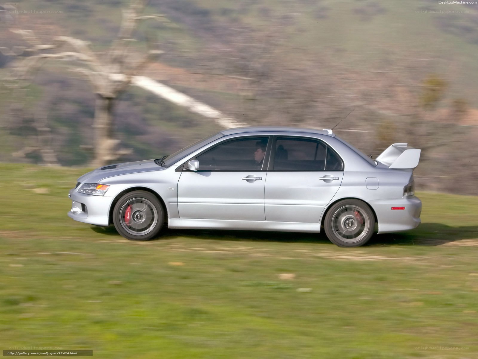 silver mitsubishi lancer evolution in motion