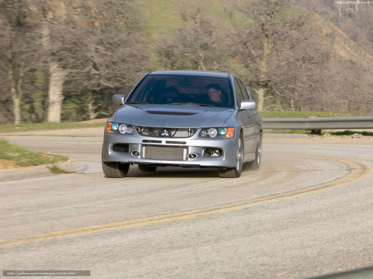 silver mitsubishi lancer evolution on winding road