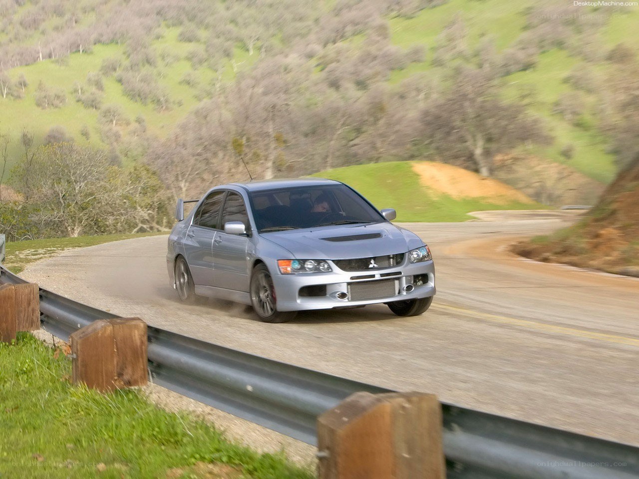 silver mitsubishi lancer evolution on winding road