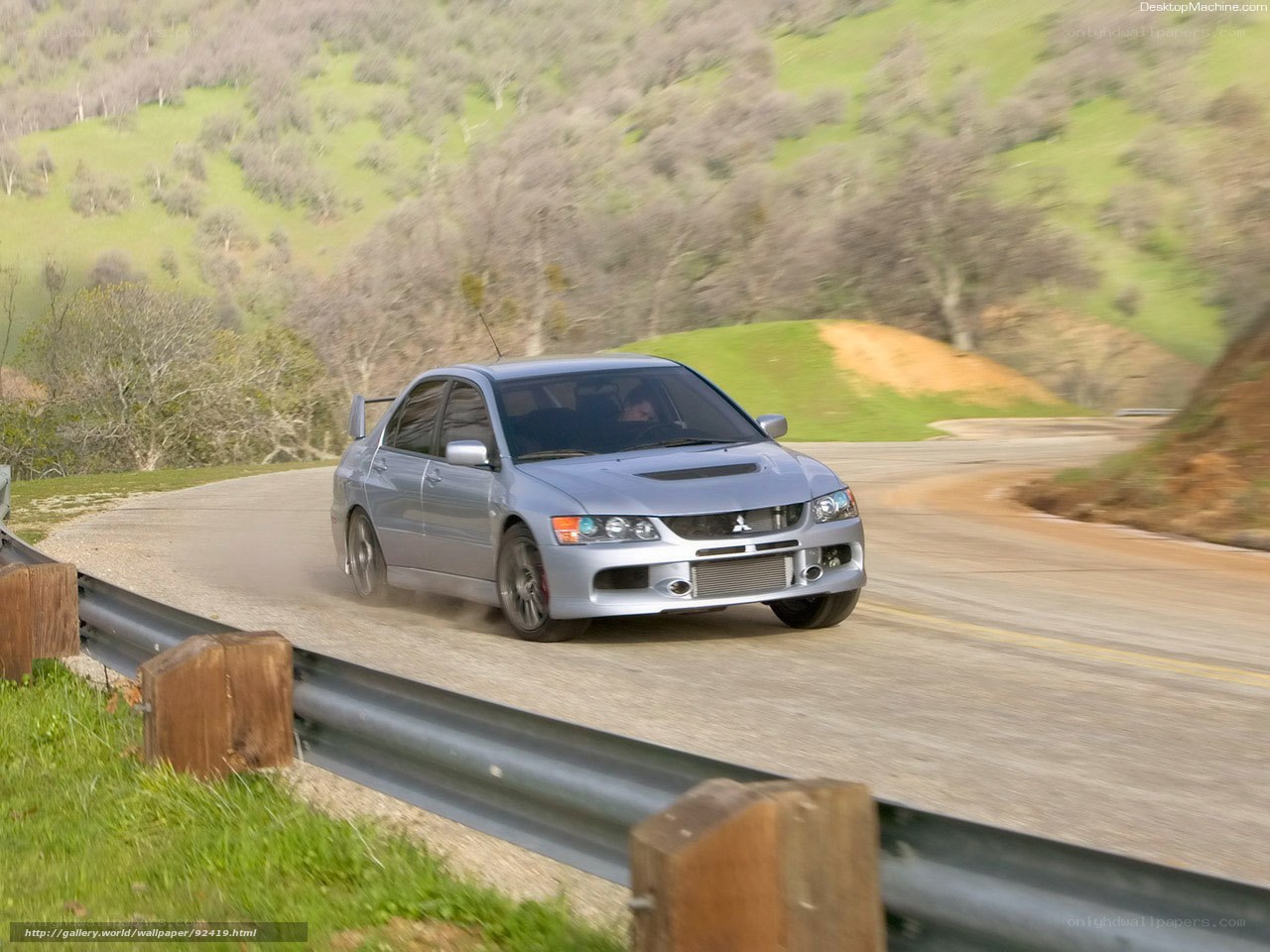 silver mitsubishi lancer evolution on winding road