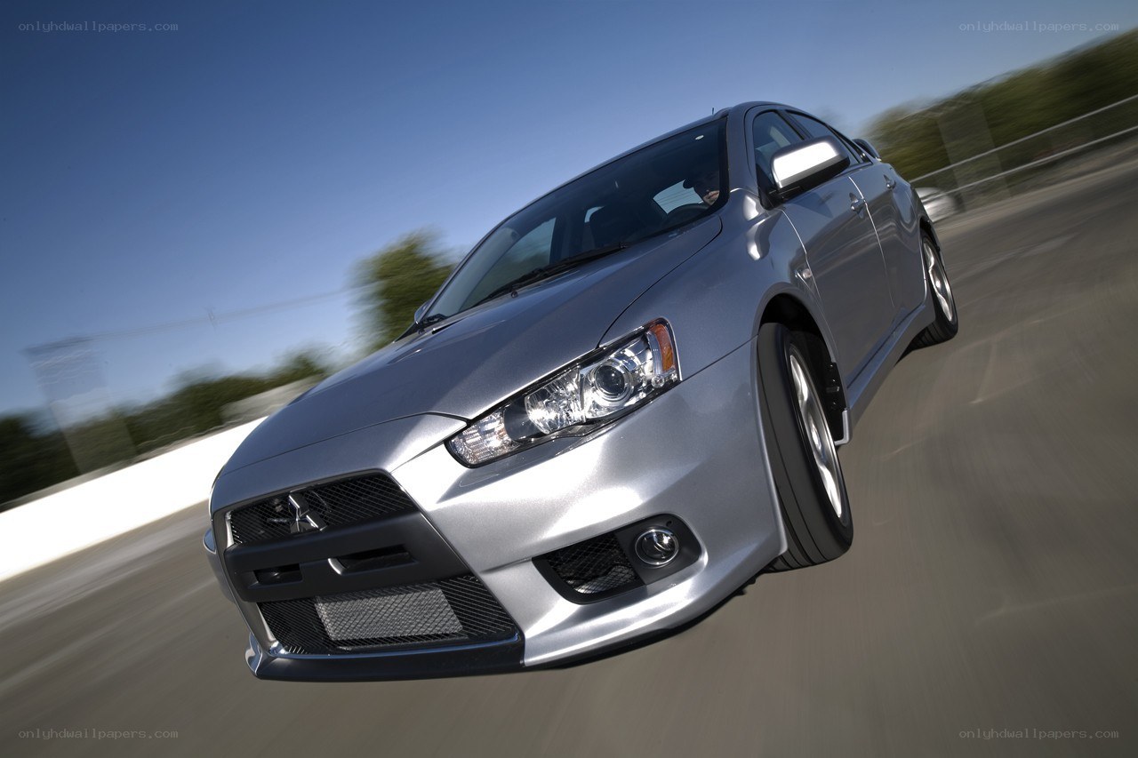 silver mitsubishi lancer in motion