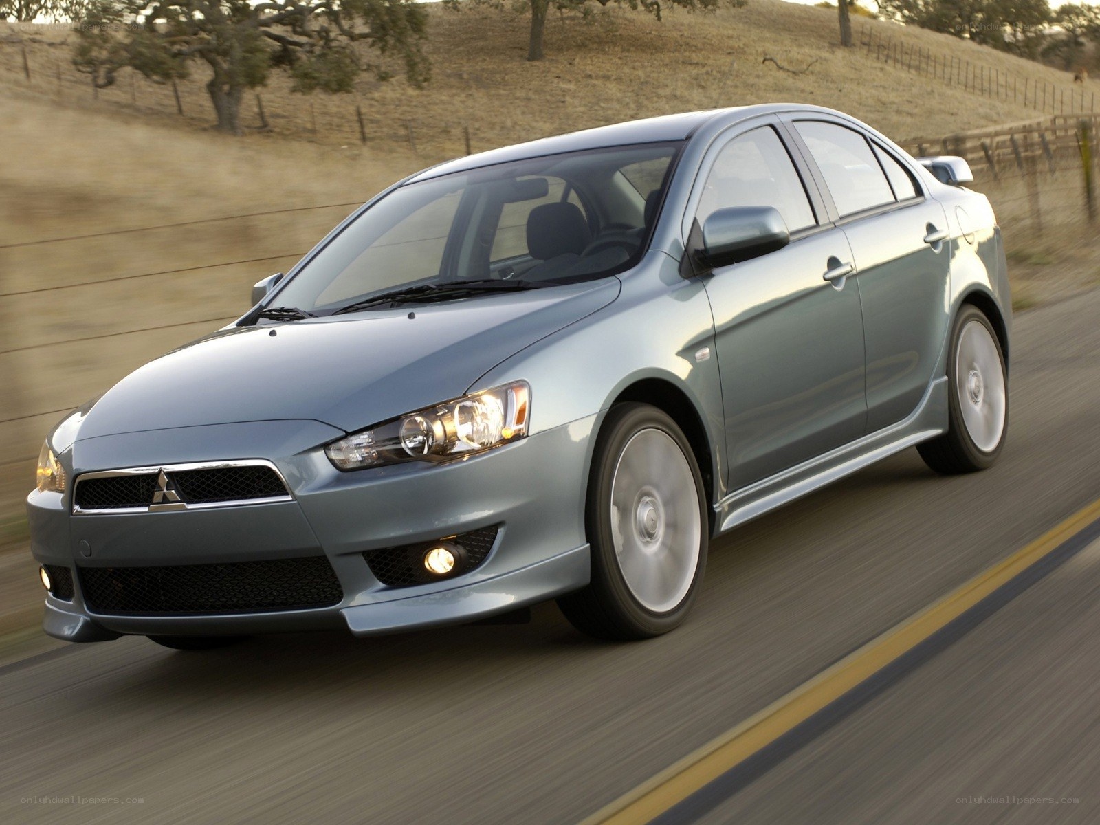 silver mitsubishi lancer in motion