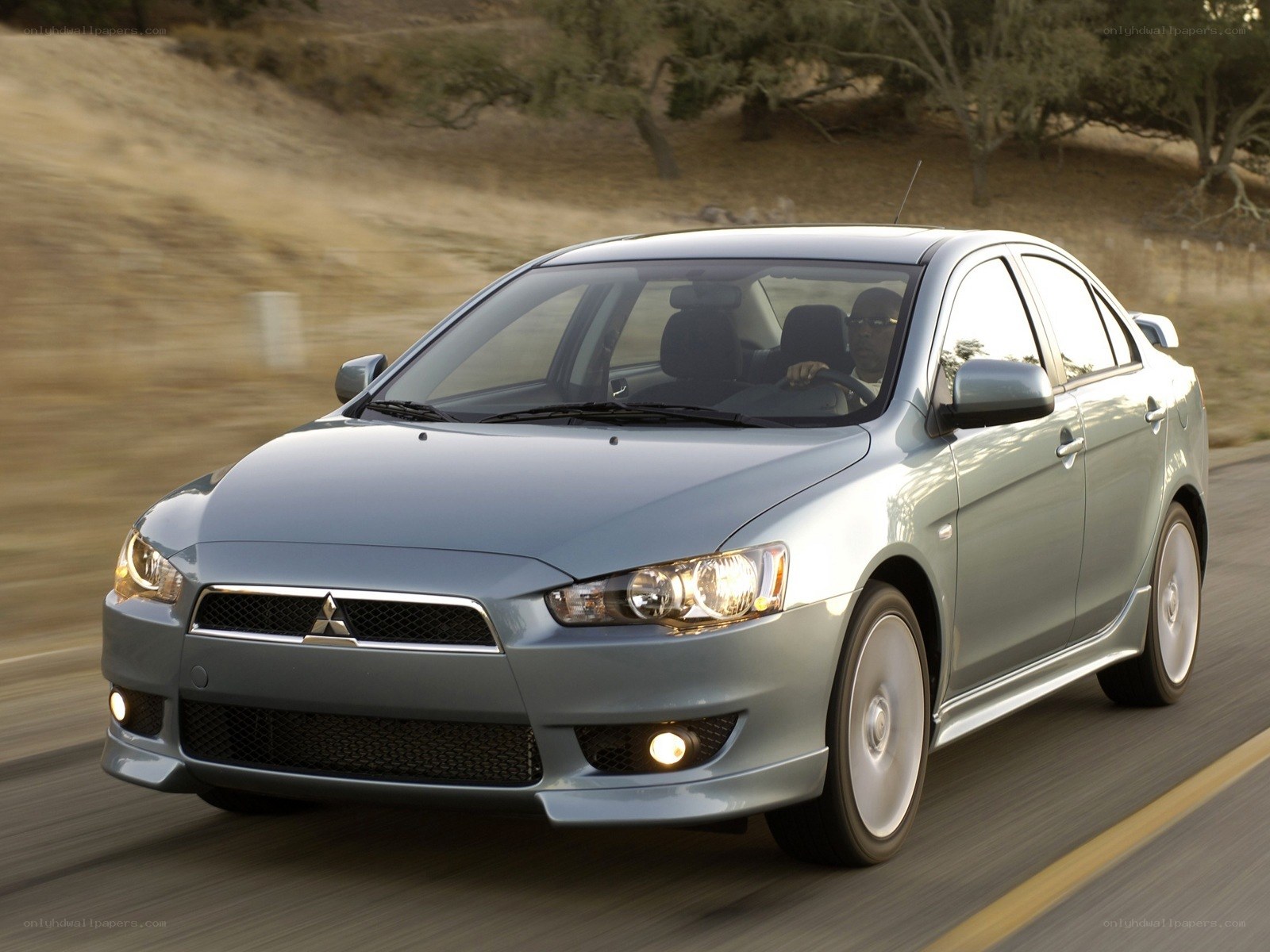 silver mitsubishi lancer in motion