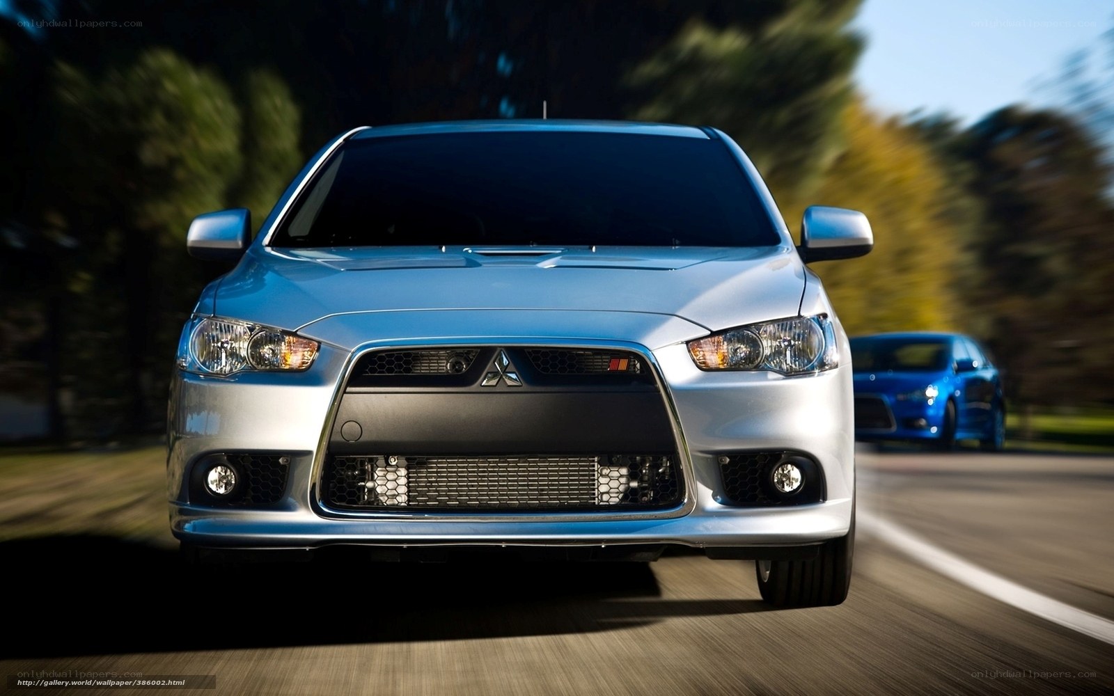 silver mitsubishi lancer in motion