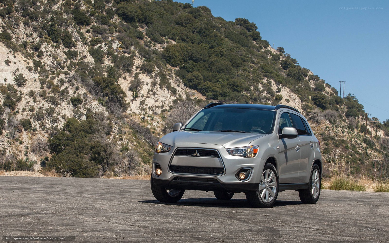 Silver Mitsubishi SUV on a road