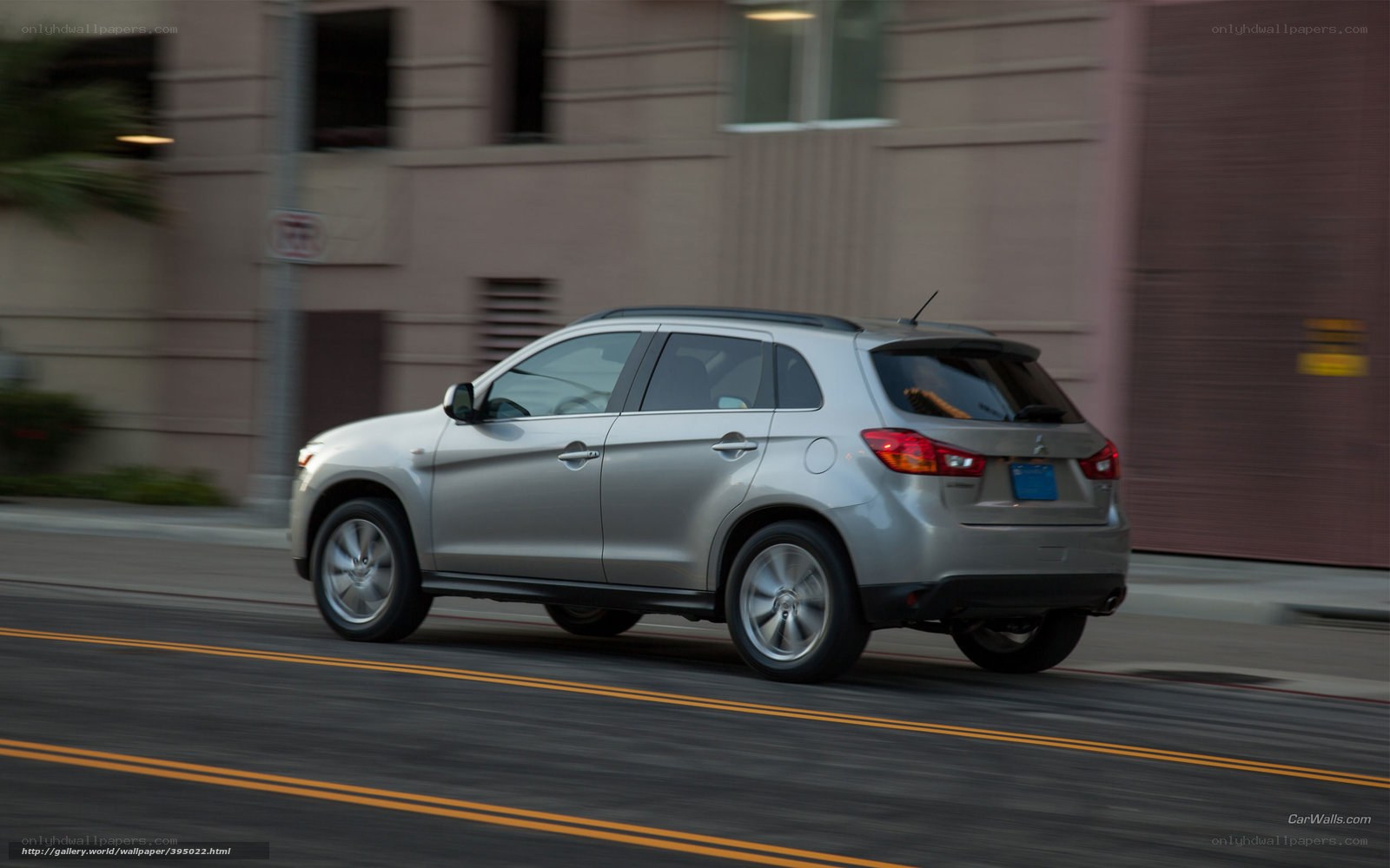 silver mitsubishi suv on city street