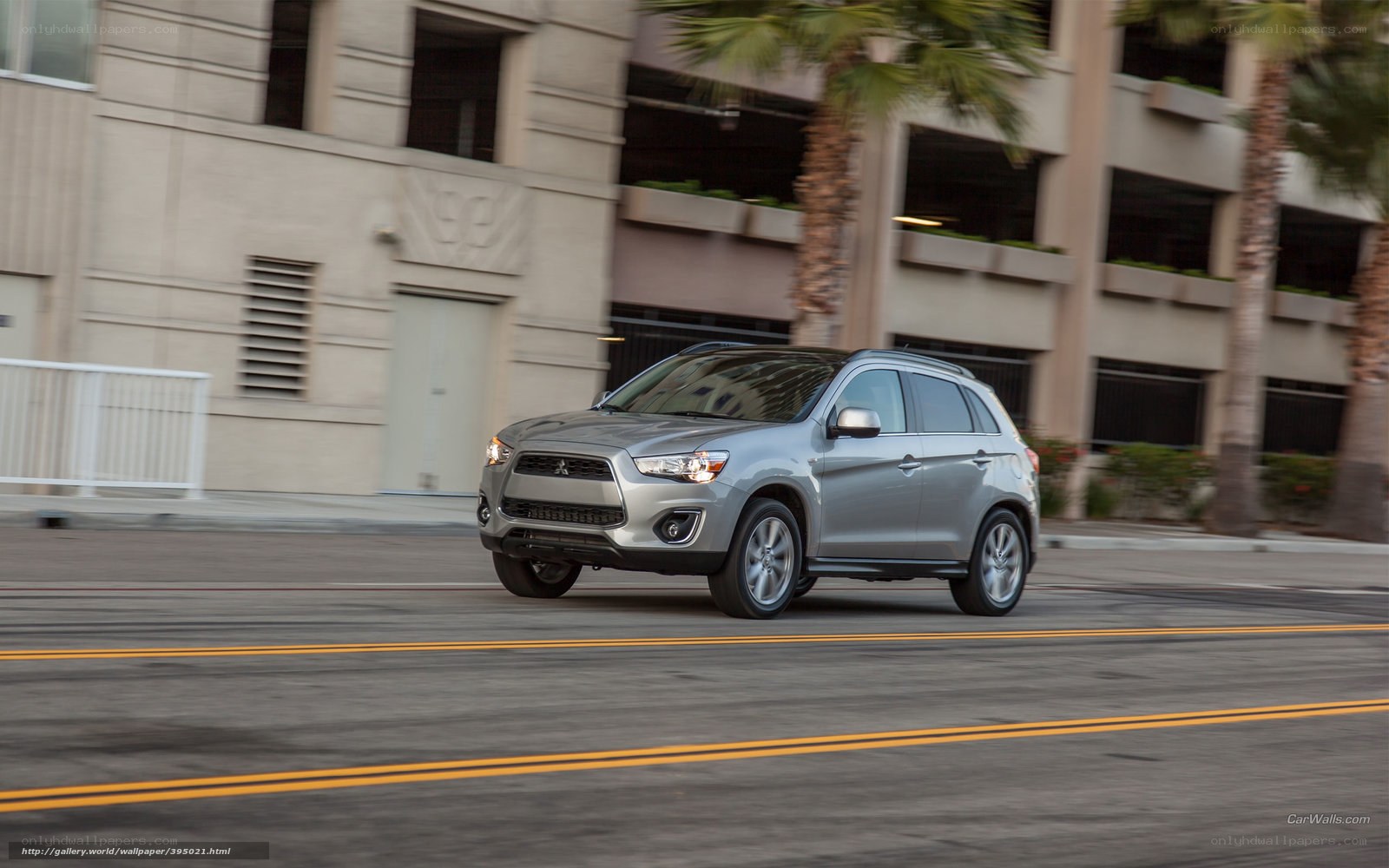 silver mitsubishi suv on city street
