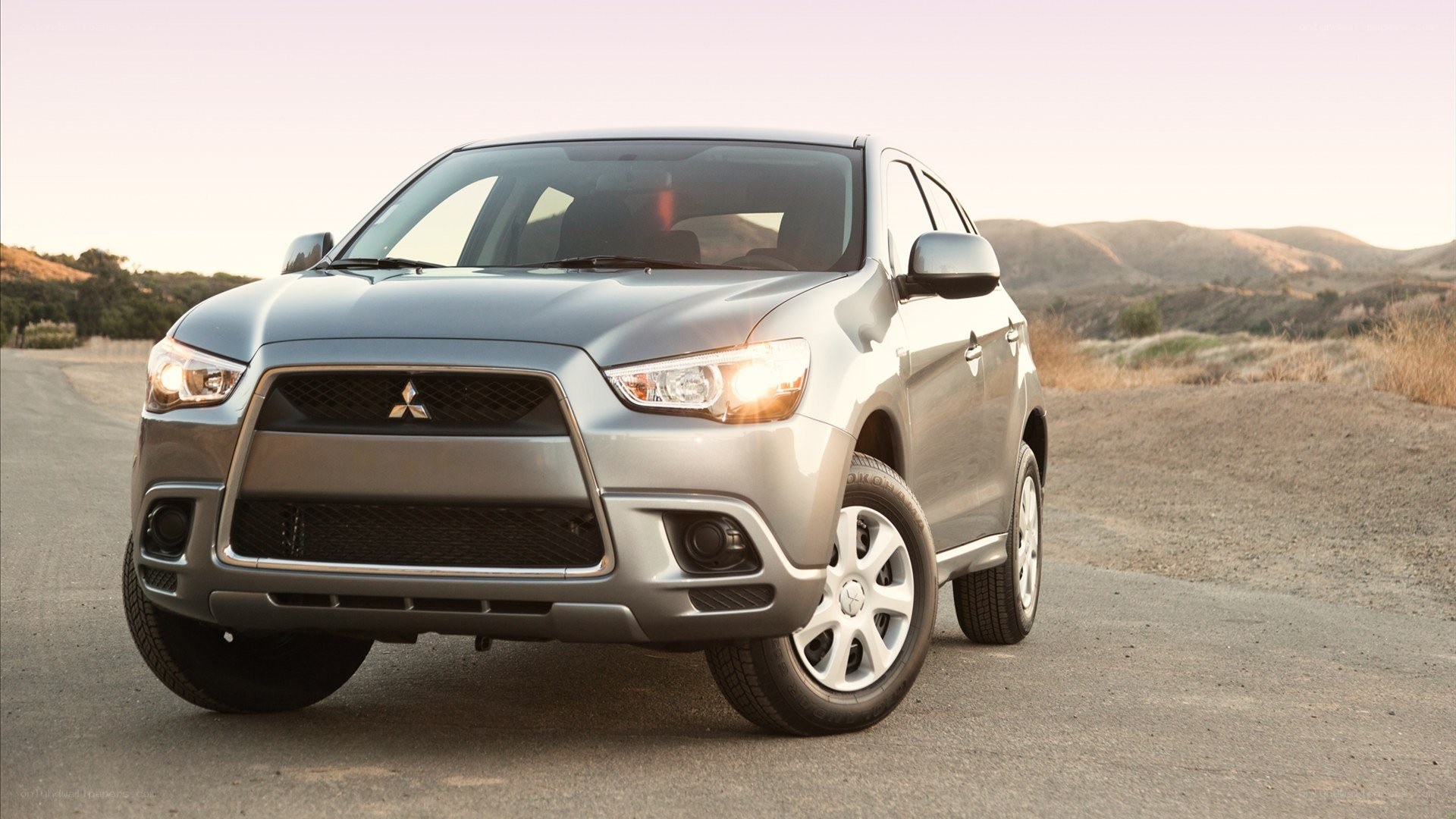 silver mitsubishi suv on road