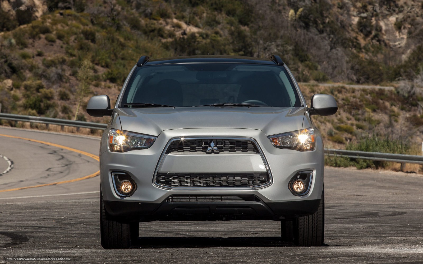Silver Mitsubishi SUV on winding road