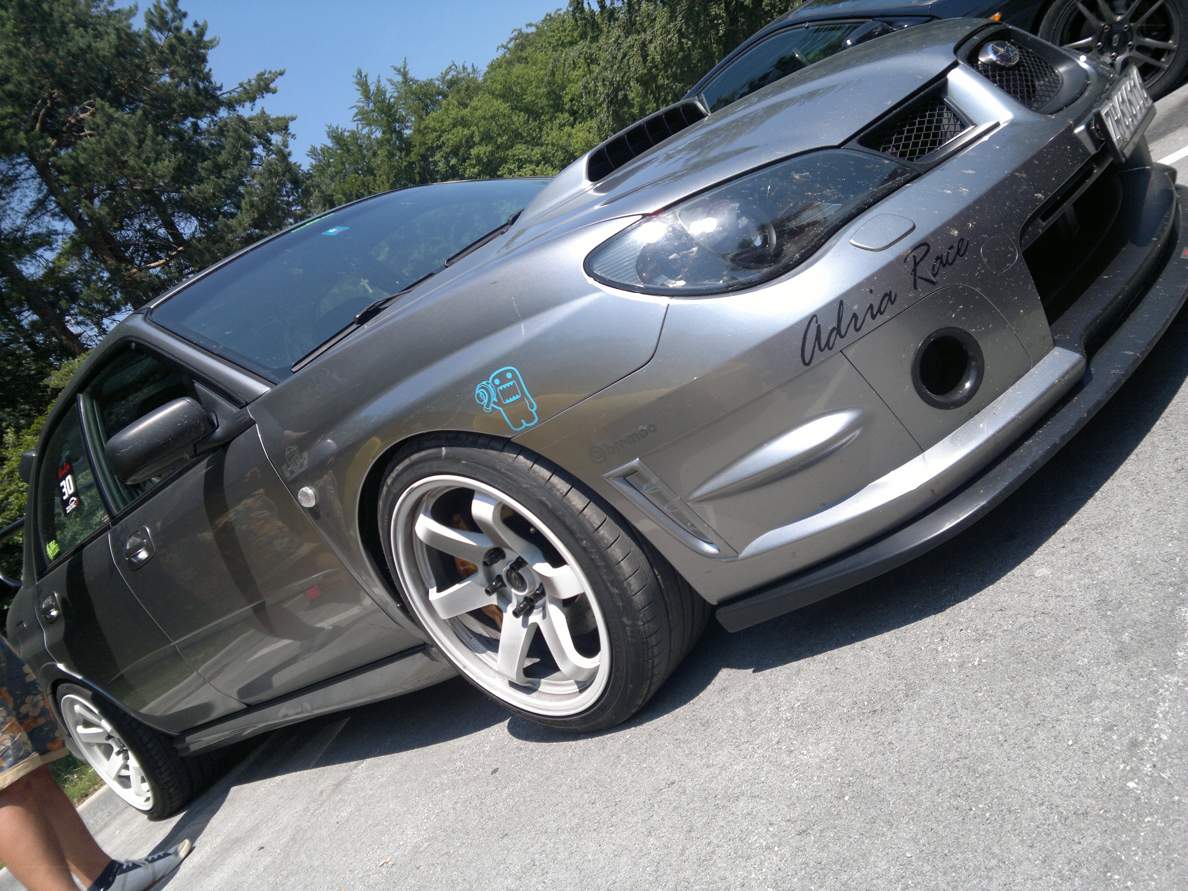 silver modified car at outdoor event
