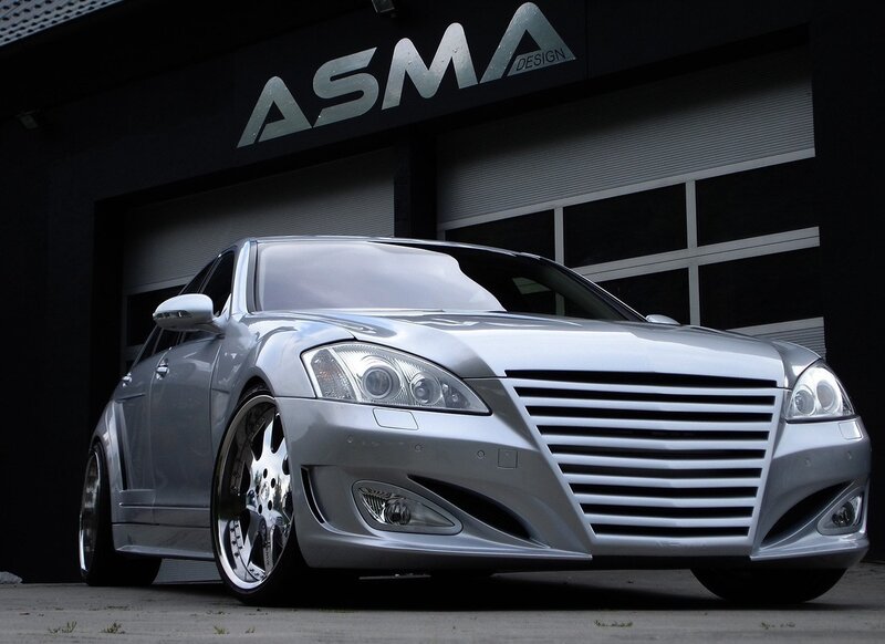 Silver modified sedan in front of garage