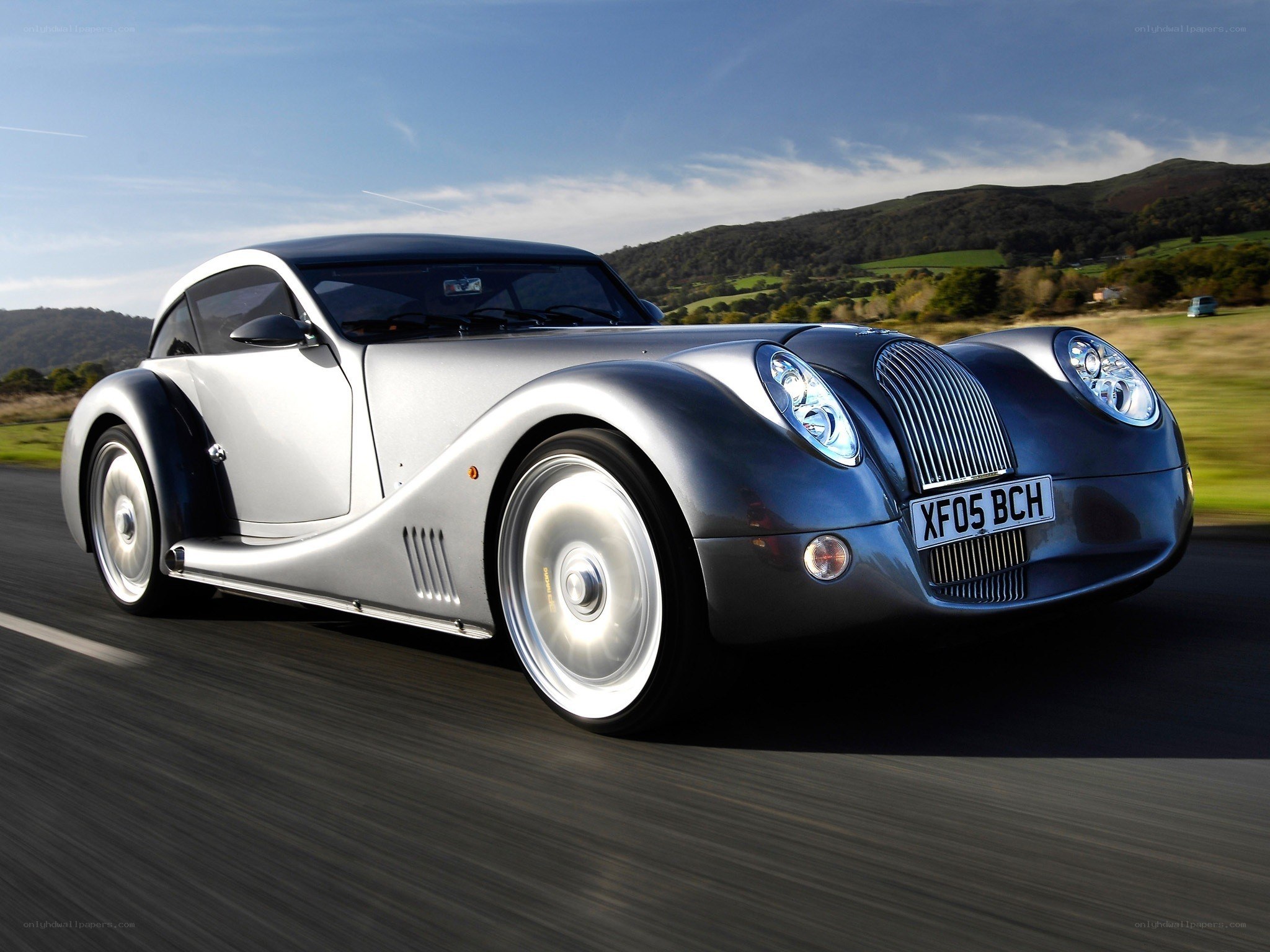 Silver Morgan car on a road