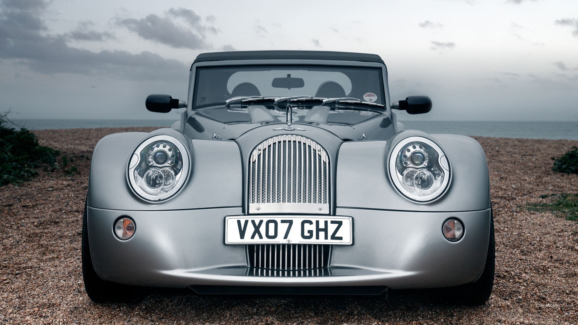 Silver Morgan car on beach