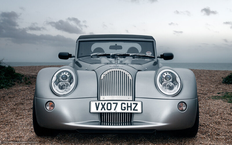 Silver Morgan car on beach