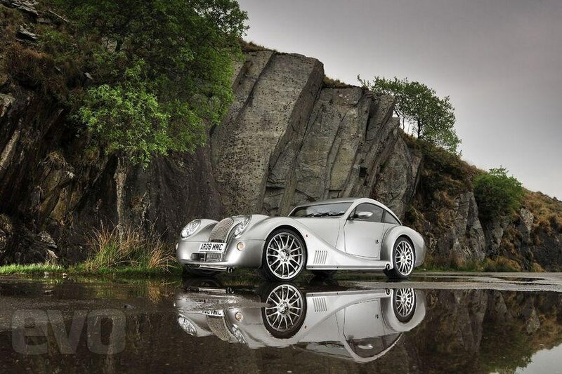 Silver Morgan car on wet road