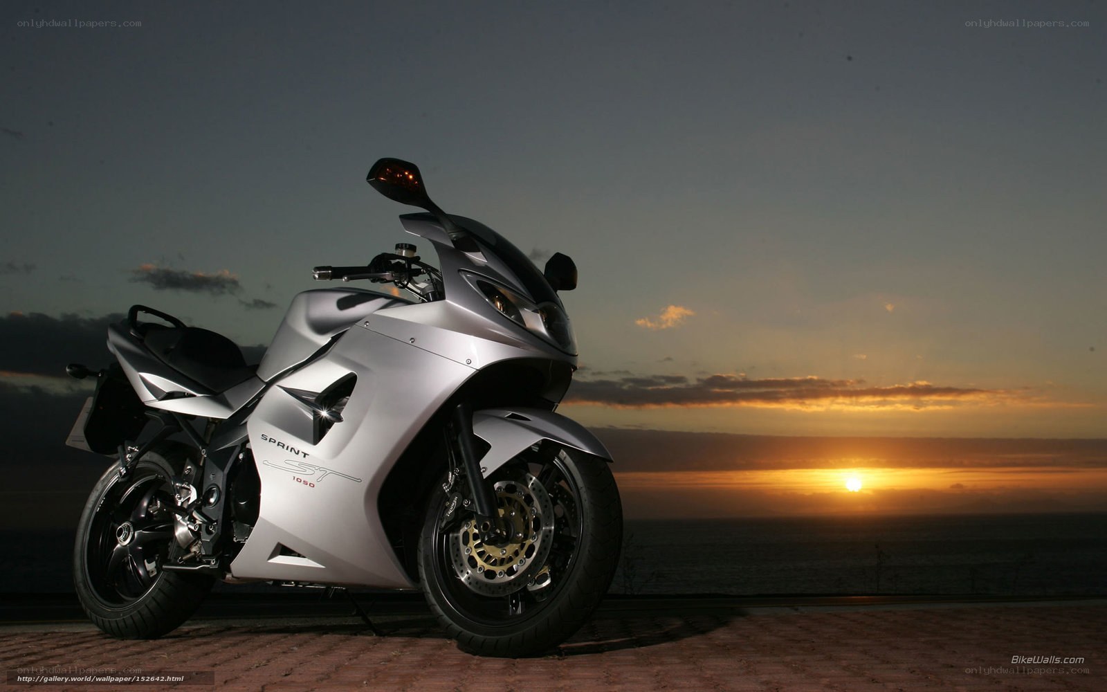 Silver motorcycle at sunset