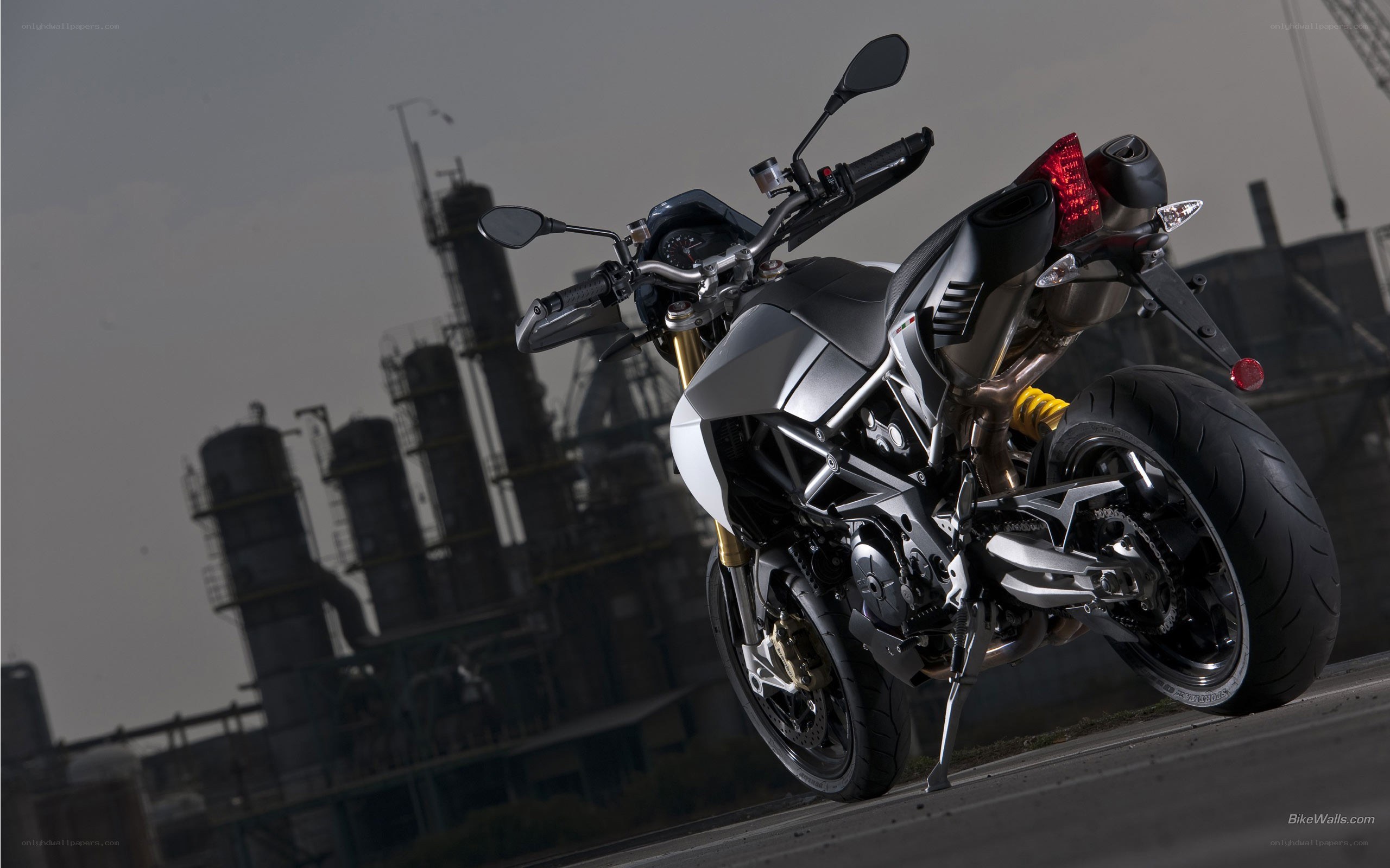 silver motorcycle in industrial setting