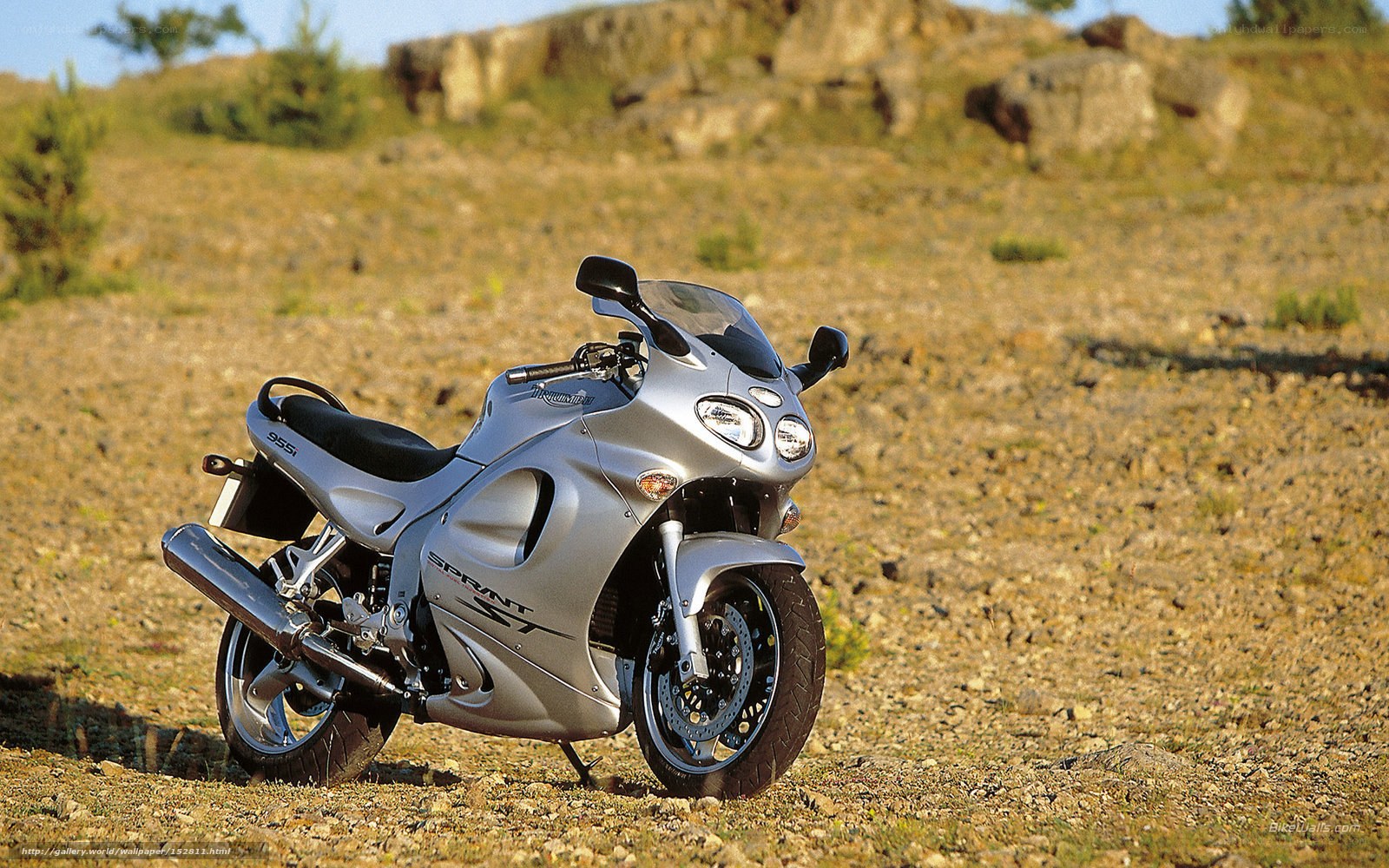 Silver motorcycle on gravel
