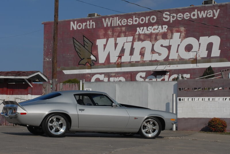 Silver muscle car at speedway