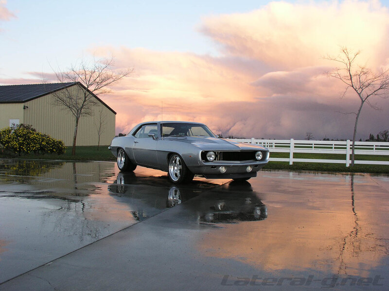 Silver muscle car at sunset