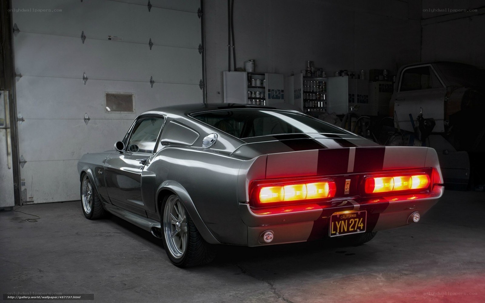 silver muscle car in garage
