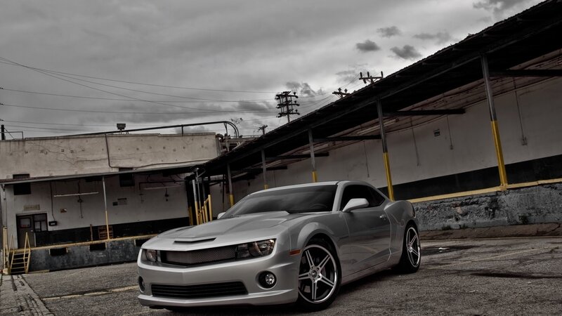 silver muscle car in industrial lot