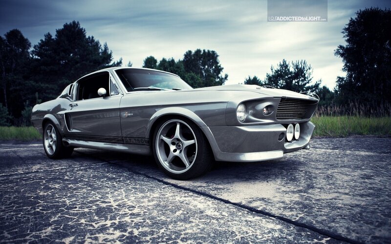 silver muscle car on cracked pavement